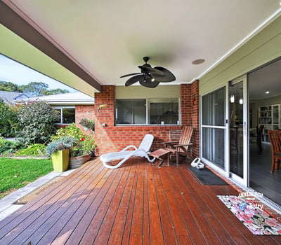Spacious outdoor deck area perfect for relaxing or entertaining, surrounded by lush greenery and inviting atmosphere.