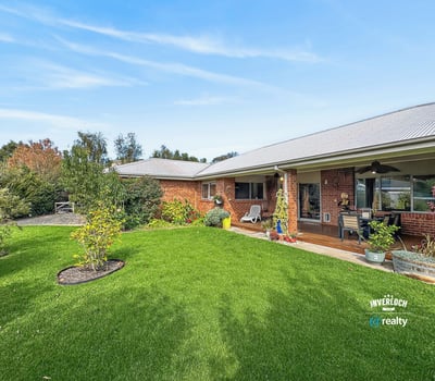 Spacious outdoor area surrounded by lush greenery, perfect for entertaining or enjoying peaceful afternoons.