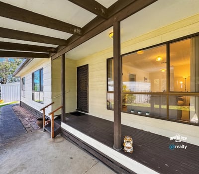 This inviting home features a spacious porch, perfect for relaxation and outdoor gatherings.