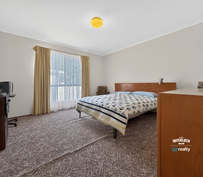 Spacious bedroom featuring large windows, ample natural light, and practical storage solutions for everyday convenience.