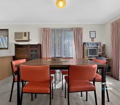 Bright dining area featuring a spacious table and large windows that invite natural light.