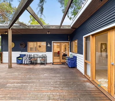Spacious deck perfect for outdoor entertaining, seamlessly blends indoor and outdoor living in a picturesque setting.