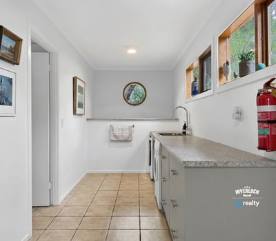 Bright and functional laundry space featuring natural light, ample counter space, and modern cabinetry.