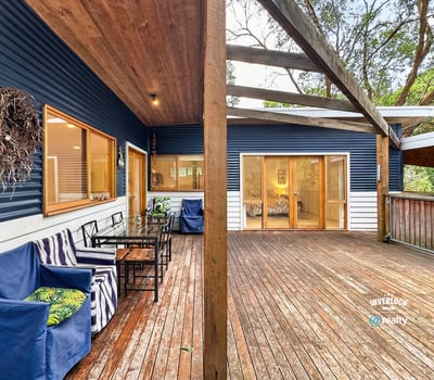 Spacious outdoor deck offers seamless indoor-outdoor living, perfect for entertaining amid a tranquil natural setting.