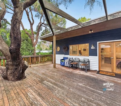 Spacious outdoor deck surrounded by nature, perfect for entertaining or relaxing in a tranquil setting.