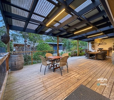 Discover this inviting outdoor space, perfect for entertaining and surrounded by lush greenery and tranquility.