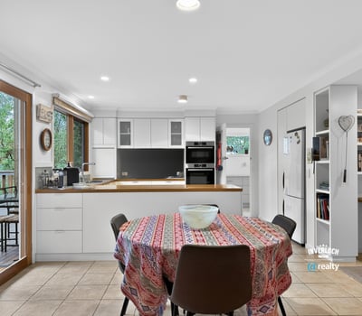 Bright, open kitchen with modern appliances and a spacious dining area, perfect for gatherings.
