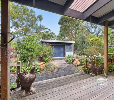 Nestled in lush surroundings, this property features a modern shed and vibrant landscaping perfect for outdoor enthusiasts.