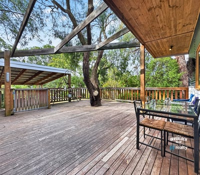 Spacious outdoor deck surrounded by nature, perfect for entertaining or relaxing in a private setting.
