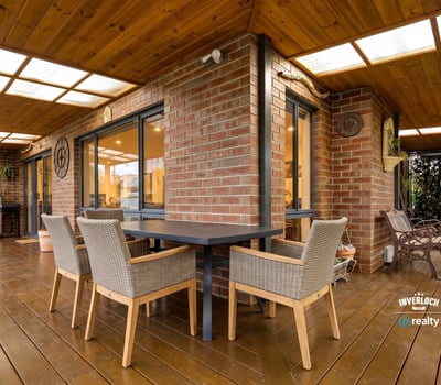 Spacious outdoor patio with dining area and built-in grill, perfect for entertaining and enjoying gatherings.