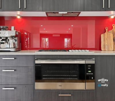 Modern kitchen featuring sleek cabinetry, a vibrant backsplash, and high-end appliances for culinary enthusiasts.