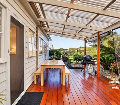 Enjoy outdoor living on this spacious deck, surrounded by lush greenery and perfect for entertaining.