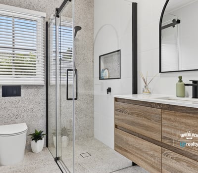 Modern bathroom featuring sleek lines, a spacious shower, and ample natural light for a refreshing ambiance.