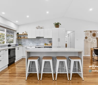 Bright, open kitchen with modern appliances, spacious island, and inviting dining area for entertaining.
