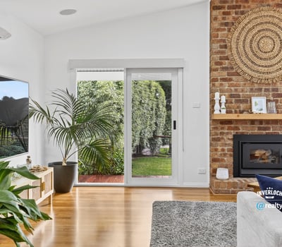 Bright living space featuring a cozy fireplace, modern amenities, and seamless indoor-outdoor access.