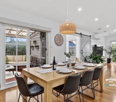 Spacious dining area with natural light, leading to a cozy outdoor retreat for entertaining.