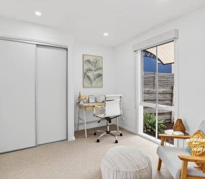 Bright and functional office space featuring natural light, modern furnishings, and streamlined storage solutions for productivity.