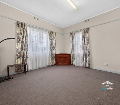 Spacious room featuring large windows, abundant natural light, and versatile flooring for various designs.
