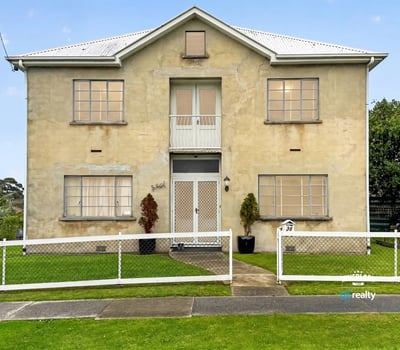 Spacious two-story residence featuring distinct architecture and ample outdoor space for relaxation and activities.