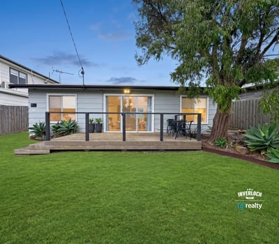 This inviting home features a spacious backyard and modern deck, perfect for outdoor gatherings and relaxation.