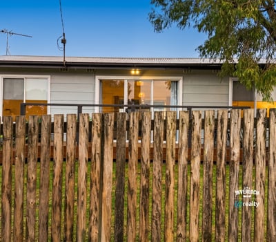Cozy home with a welcoming front porch, perfect for enjoying outdoor moments in a friendly neighborhood.
