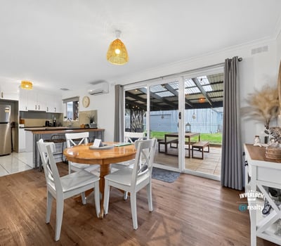 Bright dining area opening to a covered patio, perfect for indoor-outdoor living and entertaining.