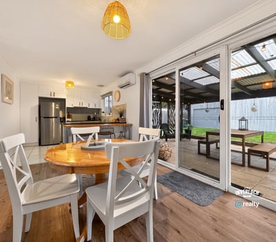 Bright, open-plan dining area seamlessly connects to an outdoor space, perfect for gatherings and relaxation.