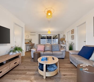 Spacious living area featuring modern amenities and abundant natural light, perfect for relaxation and entertaining.