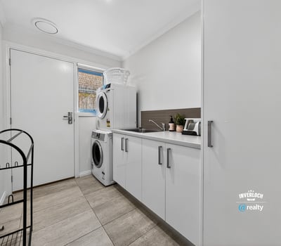 Bright and functional laundry area featuring modern appliances and practical storage solutions to enhance convenience.
