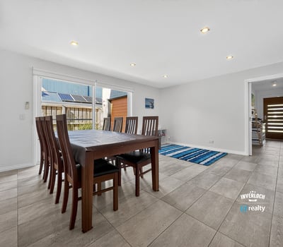 Spacious dining area with abundant natural light, featuring a versatile layout and easy access to outdoor spaces.