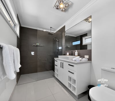 Modern bathroom featuring sleek finishes, spacious layout, and abundant natural light, perfect for relaxation.