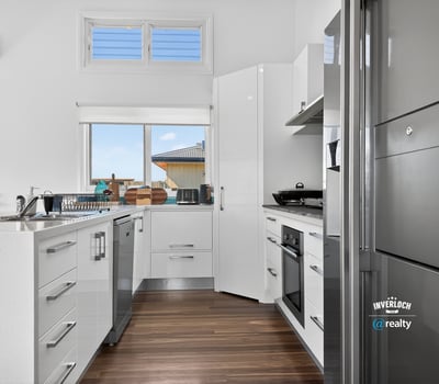 Bright and modern kitchen featuring sleek cabinetry and ample counter space, perfect for culinary enthusiasts.