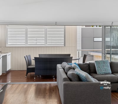 Bright and spacious living area seamlessly connects to a private outdoor space, perfect for relaxation.