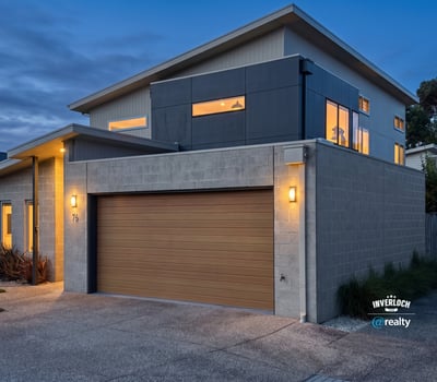 Modern two-story home featuring large windows, contemporary design, and convenient garage access in a vibrant neighborhood.