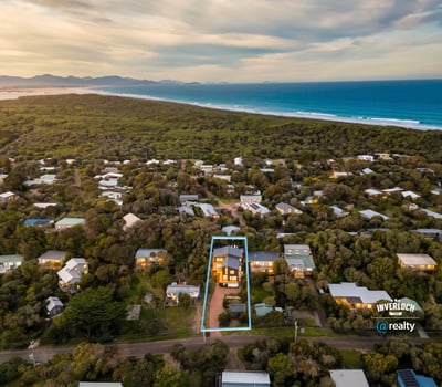 Discover a spacious home surrounded by lush landscapes, just a short stroll from beautiful coastal views.