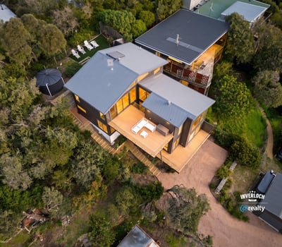 Spacious contemporary home nestled in nature, featuring expansive outdoor living areas and stunning views.
