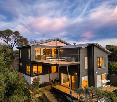 Contemporary home with expansive windows, offering breathtaking views and seamless integration with nature.