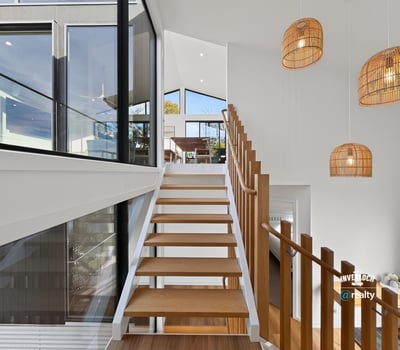 Contemporary design meets natural light in this spacious staircase, highlighting a seamless transition between levels.