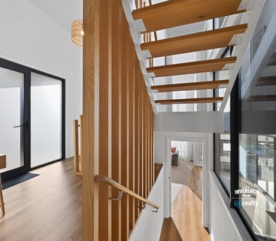 Contemporary open staircase showcases modern design, enhancing the home's inviting and spacious atmosphere.