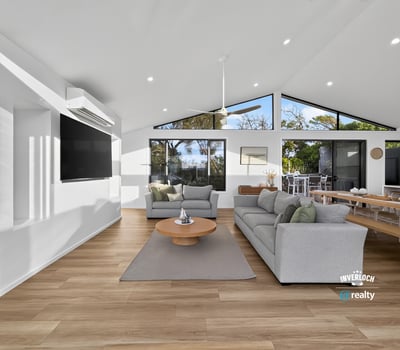 Bright and airy living space with large windows offering stunning views and seamless indoor-outdoor flow.