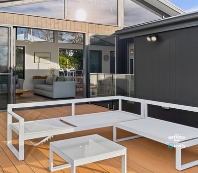 Bright outdoor living space seamlessly connects to an inviting open-plan interior, perfect for entertaining and relaxation.