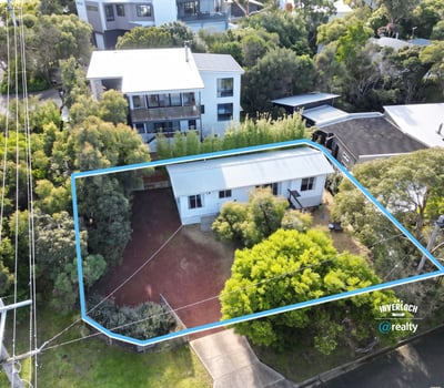 Spacious property surrounded by lush greenery, featuring potential for expansion and convenient access to amenities.