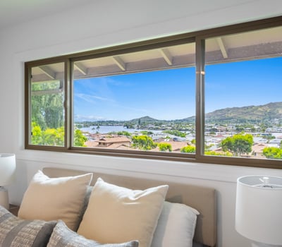 Bright bedroom featuring expansive windows that showcase stunning panoramic views of the surrounding landscape.