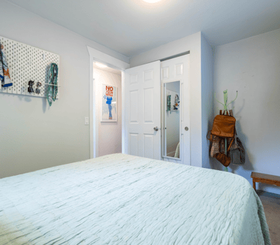 Cozy bedroom featuring a spacious layout, practical storage solutions, and convenient access to nearby amenities.