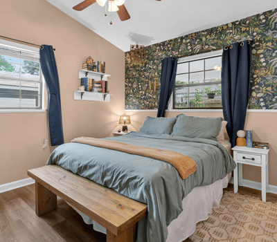 Cozy primary bedroom with ample natural light, perfect for relaxation.