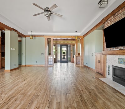 A custom fireplace, built-in cabinetry, and architectural wood accents anchor this living space, offering both style and comfort in a well-appointed Phoenix home.