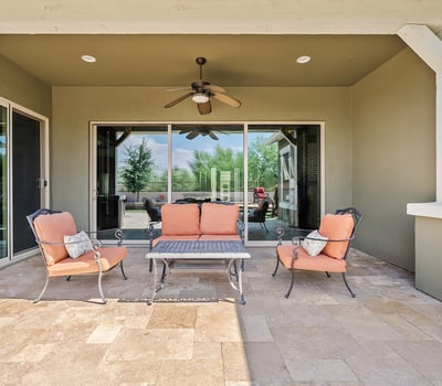 Stay cool and comfortable on this covered patio featuring ceiling fan, shade, and seamless flow to the yard ideal for Phoenix s sunny days and desert evenings.