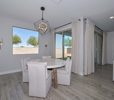 Tucked beside large windows and sliders, this intimate dining area invites sunlight and backyard views, perfect for morning meals or relaxed evenings.