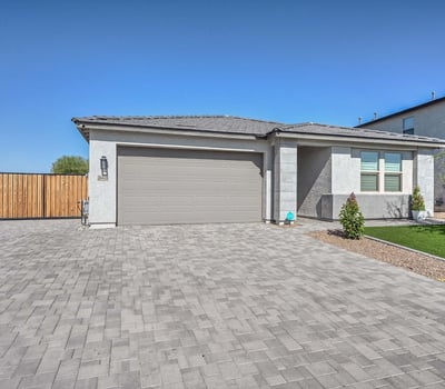 This eye-catching Peoria home showcases a sleek exterior design with a wide paver driveway, manicured synthetic turf, and a welcoming front entry. The spacious two-car garage and side RV gate offer added convenience and storage flexibility. Designed with curb appeal and low-maintenance living in mind, the home blends modern elegance with functional upgrades that enhance everyday living and energy efficiency.