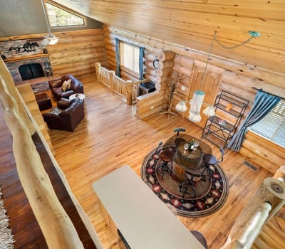 Overlook from the loft capturing the open-concept design, vaulted ceilings, and natural wood finishes that define this custom Prescott home.